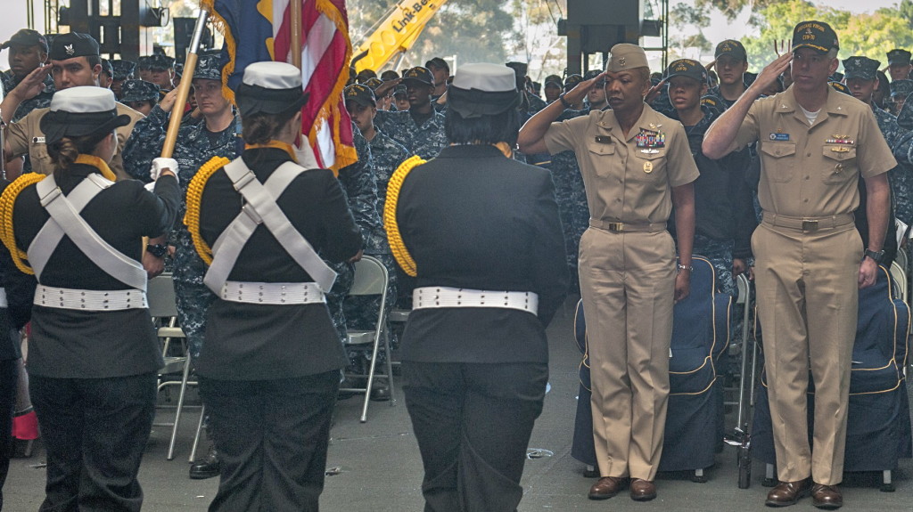 Master Chief April Beldo and Capt. Karl Thomas, USS Carl Vinson commanding officer, salute the Color Guard during a women’s heritage month celebration on Wednesday in the hangar bay. (U.S. Navy photo by Mass Communication Specialist Seaman Apprentice Daniel P. Jackson Norgart)